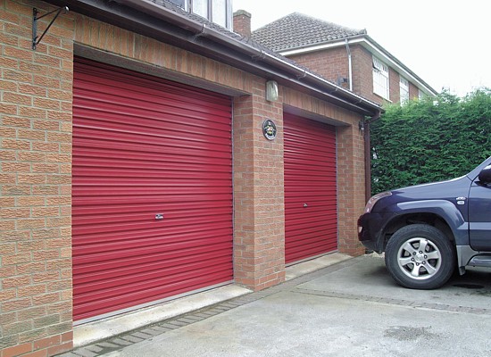 Pair of roller shutter garage doors in red